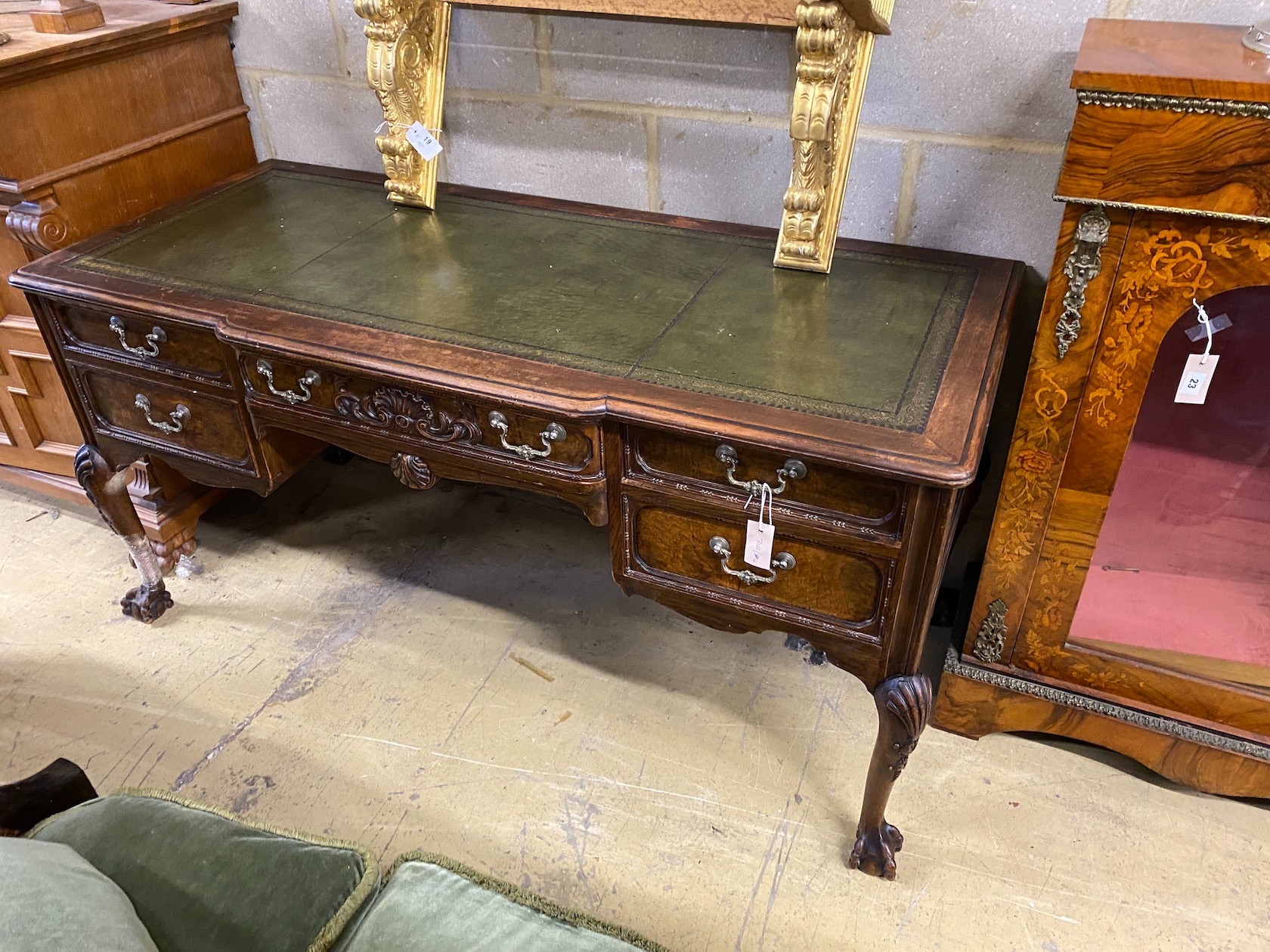 A George II style mahogany breakfront kneehole writing table, width 152cm, depth 67cm, height 76cm (one leg wormed and in need of restoration)